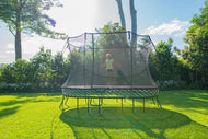 Charger l'image dans la visionneuse de galerie, A girl playing on a springfree trampoline in the backyard