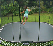 Bild in Galerie-Viewer laden, A kid playing on a backyard trampoline
