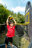 Charger l'image dans la visionneuse de galerie, Boy shooting a ball in a flexrhoop inside a trampoline