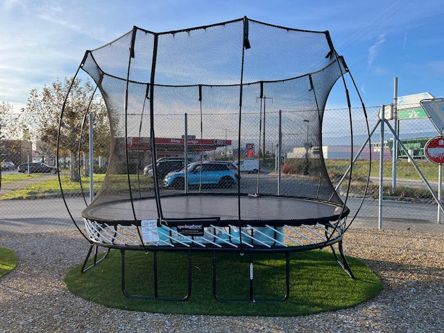 A medium-sized oval trampoline  displayed outdoors.